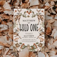 a wedding card with deers and berries on it in the middle of some leaves