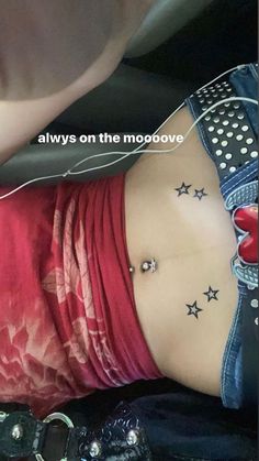 a woman with stars tattoo on her stomach