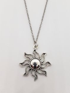 This necklace features a silver sun pendant on your choice of stainless steel chain (you choose length) or black cord necklace which is about 17.5" in length plus a 2" extender (19.5" total length). Pendant is silver-plated metal alloy and measures about 1-3/8" x 1-1/4". Please message me with any questions or special requests. Thanks for visiting! Adjustable Metal Necklace With Sun Design, Silver Sun Necklace With Sun And Moon Design, Silver Necklace With Sun And Moon Design, Silver Sun Design Pendant Necklace, Silver Metal Necklace With Sun Design, Silver Sun Design Metal Necklace, Silver Necklace With Sun Design In Metal, Sun Necklace, Sun Pendant