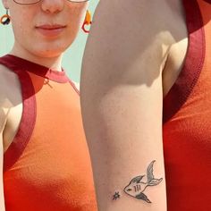 a woman with a small tattoo on her arm