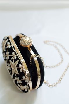 Black Clutch Wristlet for Weddings w/ Zardozi, Bead & Pearl Handwork Detailed with intricate star-shaped zardozi, luxurious pearl & bead embellishments. This black clutch bag with a stone-studded closure at the top is a must-have in your wardrobe - a versatile accessory for any party outfit! Lining: Fabric Color: Black Embroidery: Zardozi, Pearl & Bead Size & Dimensions: Height - 5 inWidth - 8 inDepth - 1.5 in Fits most of the phones. Strap: Detachable shoulder metal chain strap Closure: Compart Embroidery Zardozi, Black Clutch Bag, Black Clutch Bags, Pearl Clutch, Party Clutch, Designer Clutch, Black Embroidery, Black Clutch, Black Party