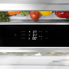 an oven with thermostaer and vegetables in it's door showing temperature