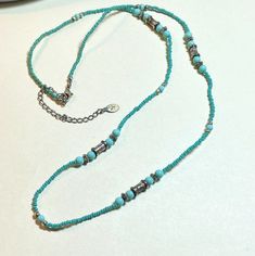 A colorful and fashionable vintage beaded long necklace from Liz Claiborne. The necklace is 27 to 30 inches long, using the chain extender.  Faux turquoise beads with silvertone metal beads mixed in.  Lobster claw clasp.  Liz Claiborne dangle hang tag. Good vintage condition, with wear and discoloration to the metal components. You can find more vintage beaded necklaces here: https://www.etsy.com/shop/OtterCatHaus/search?search_query=beaded+necklace&order=date_desc&view_type=gallery&ref=shop_search Please convo with any questions.  I combine shipping and refund overages of more than fifty cents.  Thanks for visiting today! Bohemian Silver Long Necklace With Colorful Beads, Turquoise Long Beaded Chain Necklace, Long Turquoise Necklace With Colorful Beads, Turquoise Long Necklace With Colorful Beads, Turquoise Long Beaded Necklace, Bohemian Long Beaded Necklace, Vintage Turquoise Single Strand Beaded Necklace, Turquoise Lariat Beaded Necklaces, Bohemian Silver Turquoise Necklace With Spacer Beads