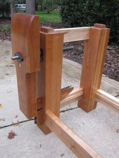 a wooden bench sitting on top of a sidewalk