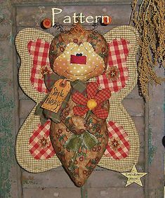 an image of a teddy bear made out of fabric on a wooden board with words written in it