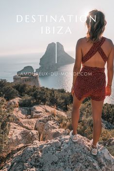 a woman standing on top of a rock next to the ocean with text that reads destination ibza