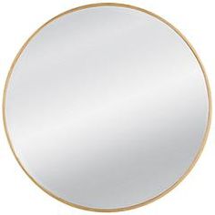 a round mirror sitting on top of a white wall