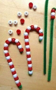 some candy canes are sitting on a table with other items to make it look like they have been made into christmas decorations