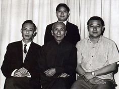 an old black and white photo of three men sitting next to each other in front of a curtain