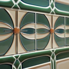 a close up view of some tiles on the wall with circles and lines in them