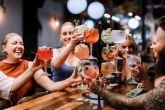 a group of people sitting at a table with drinks