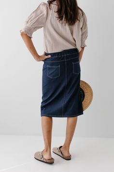 With the look of real denim but the feel of a quality knit, comfort is the key element in our exclusively designed 'Piper 'Skirt. The quick, pull on style with a fabric covered waistband makes this skirt a practical everyday option! Soft, comfortable knit denim fabric Functional Back Pockets 70% Rayon 25% Polyester 5% Spandex Wash Cold Gentle Cycle Hang to Dry Fabric covered elastic waistband Model A Height in Dark Blue 5'5" | Wearing Size Small Wearing 'Finch' Smocked Yoke Cotton Gingham Top in Gingham Top, Knit Denim, Gingham Tops, Knit Skirt, Main Street, Denim Fabric, Fabric Covered, Soft Knits, Chambray