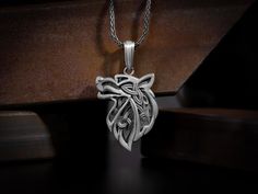 Celtic wolf ornaments pendant necklace for men in sterling silver, Scandinavian chrm jewelery, Viking fenrir wolf gift neckllace for husband The Valknut, which translates to ""slain warrior"" is a prominent symbol left by the Vikings. It was often found in association with Odin. It can be said to represent brave warriors who performed feats of valor and sacrifice for the greater good. This celtic wolf necklace features exclusive handmade engraving details, photographed with original products. Ve Viking Style Sterling Silver Pendant, Viking Sterling Silver Pendant Jewelry, Viking Style Sterling Silver Pendant Jewelry, Viking Style Wolf Design Jewelry Gift, Viking Style Sterling Silver Necklace Gift, Sterling Silver Wolf Design Jewelry Gift, Sterling Silver Wolf Design Necklace As Gift, Sterling Silver Necklace With Wolf Design As Gift, Sterling Silver Necklace With Wolf Design For Gift