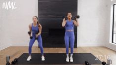 two women doing exercises with dumbbells in a gym room, while one woman looks at the camera