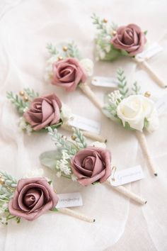 wedding boutonnieres with flowers and name tags