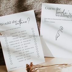 two paper signs sitting on top of a table next to each other with writing on them