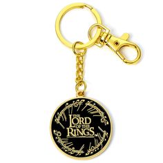 the lord of the rings keychain is shown on a white background with gold lettering