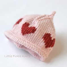 a knitted hat with hearts on it