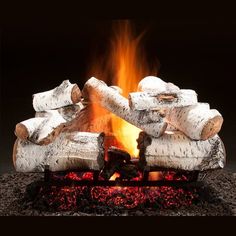 a close up of a fire with logs in the background