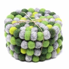 a close up of a ball made out of green and grey balls with a string on top