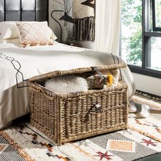 a wicker basket is sitting on top of a bed