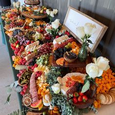 a table filled with lots of different types of food on plates and trays next to each other