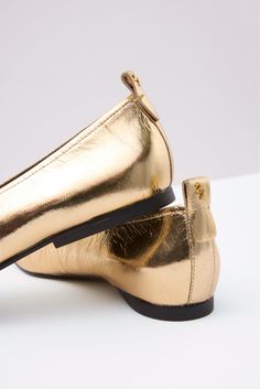 Add instant polish to your footwear collection with the Carla ballet flat by 27 EDIT Naturalizer, featuring a slip-on design, squared toe, and comfortable cushioned footbed. The gold metallic leather will make a stylish statement with any look. | 27 EDIT NATURALIZER Women's Carla Flat, Size 10, Gold Elegant Gold Flat Loafers, Casual Gold Slides With Buckle Closure, Gold Leather Slip-on Flats, Chic Gold Mules With 4-inch Heel, Gold Leather Slip-on Ballet Flats, Fall Closet, Sock Shop, Shoe Size Conversion, Footwear Collection