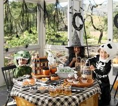 a group of people sitting around a table covered in halloween decorations