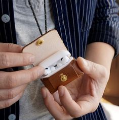 a person is holding an electronic device in their hand and it's inside the case