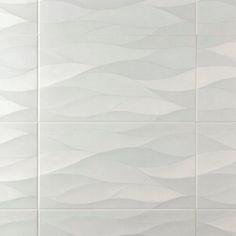 a white tiled wall with wavy lines on it