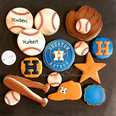 decorated cookies in the shape of baseballs, mitts, and other sports related items