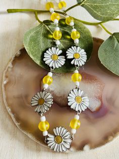 The adorable Daisy and yellow bead necklace is made with a wire chain and lobster claw connector. This necklace is the perfect accessory for any women's wardrobe.  This necklace is a great gift for her.  Necklace is a length of 19" - 21" Yellow Flower-shaped Beaded Necklaces, Yellow Flower-shaped Beaded Necklace, Bohemian Yellow Necklace With Flower Charm, Adjustable Yellow Flower Charm Necklace, Adjustable Yellow Flower Pendant Necklace, Yellow Adjustable Flower Pendant Necklace, Yellow Flower Necklaces For Jewelry Making, Yellow Beaded Flower Necklace Gift, Yellow Beaded Flower Necklace As Gift