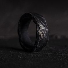 "A love forged in iron. This ring is built strong to endure the trials and tribulations that inevitably will come your way. Perfect as an engagement band or an affordable alternative to wedding rings. Each piece is made to order for you and no one else. We craft pieces with a darker tone in mind to elevate your style with a hint of the moon's dark side. 5% of our sales are donated toward ending human trafficking and another 5% toward aiding those living with disabilities. Ring Features: - Single piece formation means the ring has never been broken. Because no welding is involved, there's no \"weakest seam\" for the ring to split upon. - Master your style. The timeless look lends itself well to casual and formal wear alike. - Oil quenched steel gives the ring its dark hand-forged look. - No Viking Wedding Band, Norse Ring, Mens Wedding Rings Black, Viking Wedding Ring, Goth Ring, Pagan Wedding, Promise Rings For Him, Viking Wedding, Black Wedding Band