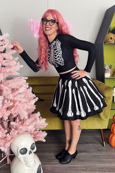 Welcome to our Christmas Mourning collection! This skirt features our custom bones artwork! This skirt fabric is a poly blend, it's a stretchy material similar to leggings fabric. The waistband is stretchy and is very comfortable. Styled here with a short petticoat for extra fullness. This is mid length style skirt which is shorter than my gathered skirts BUT they are not super short! This skirt is longer in the back by an inch and hits above the knee in the front. • 82% polyester, 18% spandex• Halloween Stretch Mini Skirt, Fitted Halloween Skirt, Stretch Halloween Mini Skirt, Halloween Costume Party Stretch Mini Skirt, Halloween Stretch Mini Skirt For Costume Party, Stretch Mini Skirt For Halloween Costume Party, Fitted Mini Skirt For Halloween Costume Party, Fitted Halloween Bottoms With Skull Print, Stretch Skirt For Costume Party