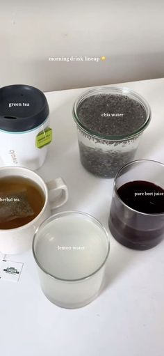 four different types of coffee in bowls on a white counter top with labels describing them