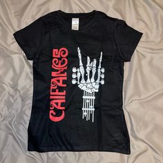 Size Small In Women Size New Caifanes Black Short Sleeve Tops With Band Logo, Black Short Sleeve Top With Band Logo, Black Screen Print Top For Concert, Black Rocker T-shirt With Band Logo, Black Top With Front Print For Concert, Black Skull Print Band Merch Tops, Black Band Logo Tops For Concert, Black Band Logo Top For Concert, Black Tops With Band Logo For Concerts