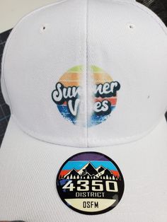 a white hat with the words summer vibes on it and a sticker that says 350 district dsm