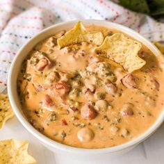 a bowl of quesadilla soup with tortilla chips on the side