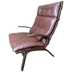 a brown leather chair sitting on top of a wooden frame