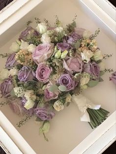 a bouquet of flowers in a white frame