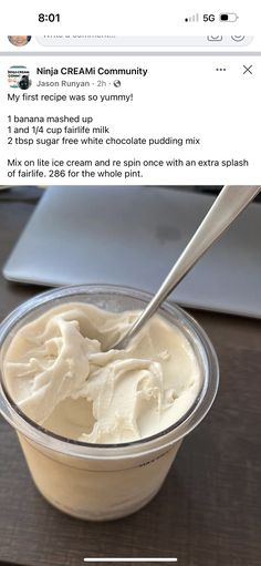 a cup filled with whipped cream on top of a wooden table