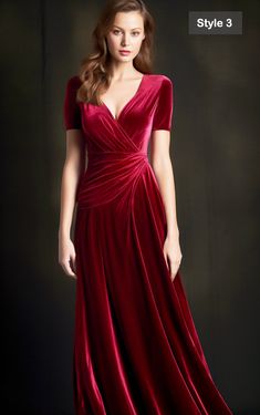 a woman in a long red dress posing for the camera with her hands on her hips