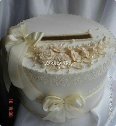 a white wedding cake decorated with flowers and pearls