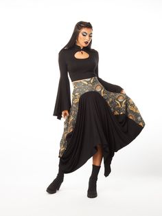 OVERVIEW:  Step into the mystical allure of the Celestial Skirt, a masterful blend of gothic elegance and celestial wonder. Inspired by the mysteries of the universe, this high-waisted maxi skirt features a sculptural design with a fluid drape at the center and contrasting fabrics for a striking visual appeal. The celestial-themed upper fabric, adorned with sun and moon motifs, transitions gracefully into a solid black fabric at the center and bottom, creating a dramatic and versatile piece. Its Celestial Skirt, Witchy Skirt, Celestial Print, Gothic Elegance, Skirt Draping, High Waisted Maxi Skirt, Witchy Fashion, Jersey Skirt, Black Jersey