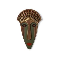 a wooden mask on a white wall with red and green designs in the shape of a woman's face