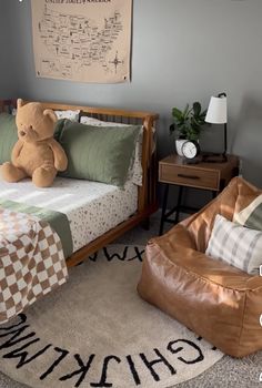 a child's bedroom with a teddy bear on the bed and checkered blanket