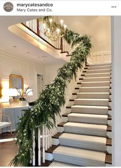 the stairs are decorated with greenery and garland