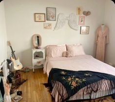 a bed room with a neatly made bed and pictures on the wall