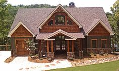 a large house with stone and wood accents