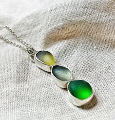 Handmade Trio of Seaglass Vertical Necklace Pendant Immerse yourself in the natural beauty of the ocean with our exquisite Trio of Seaglass Necklace Pendant. This handcrafted piece features three genuine seaglass treasures in stunning shades of green, white, and yellow, elegantly arranged in a vertical design. Each piece of seaglass has been naturally smoothed by the waves, making this pendant a unique and captivating addition to your jewellery collection. Beautiful Green, White, and Yellow Seag Elegant Handmade Sea Glass Necklace, Sea Glass Large Pendant Necklace, Handmade Ocean-inspired Sea Glass Necklaces, Blue Sea Glass Necklace, Nickel-free Blue Sea Glass Jewelry, Sea Glass Necklace, Sea Glass, Shades Of Green, Timeless Beauty